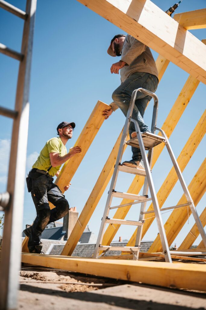 dachdecker-website-kitzingen Dachdecker bei der Arbeit auf einem Dach mit Blick über Kitzingen. Zeigt Kompetenz bei Dacharbeiten in der Region.
